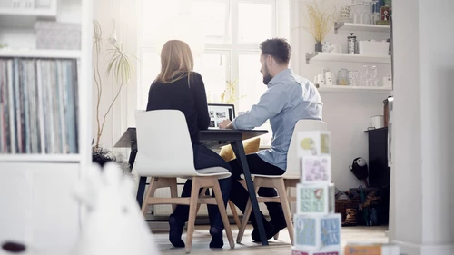Couple sitting at desk with laptop