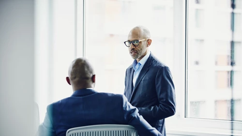 Mature businessmen discussing